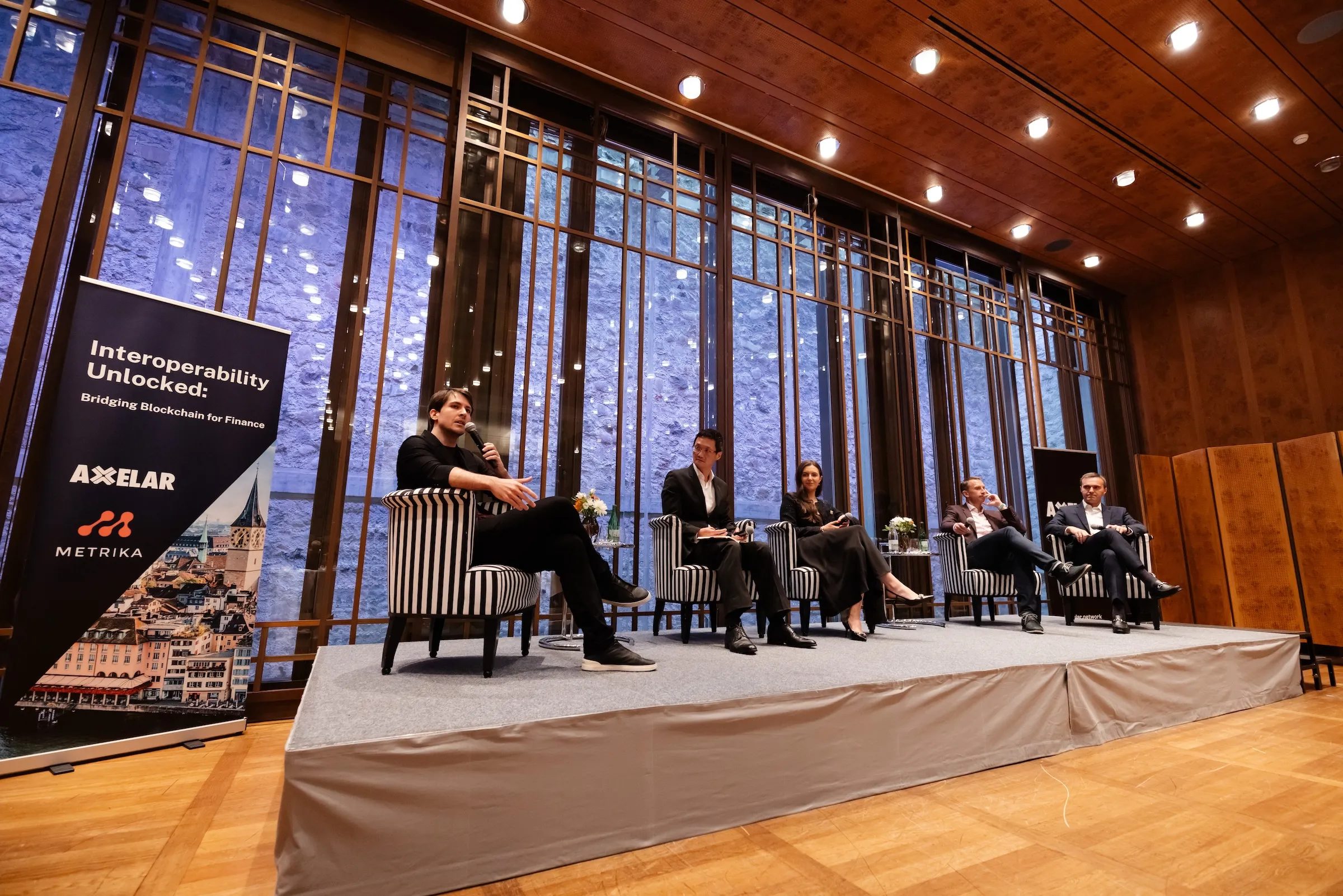 Interoperability Unlocked conference panel with Axelar and Metrika branding