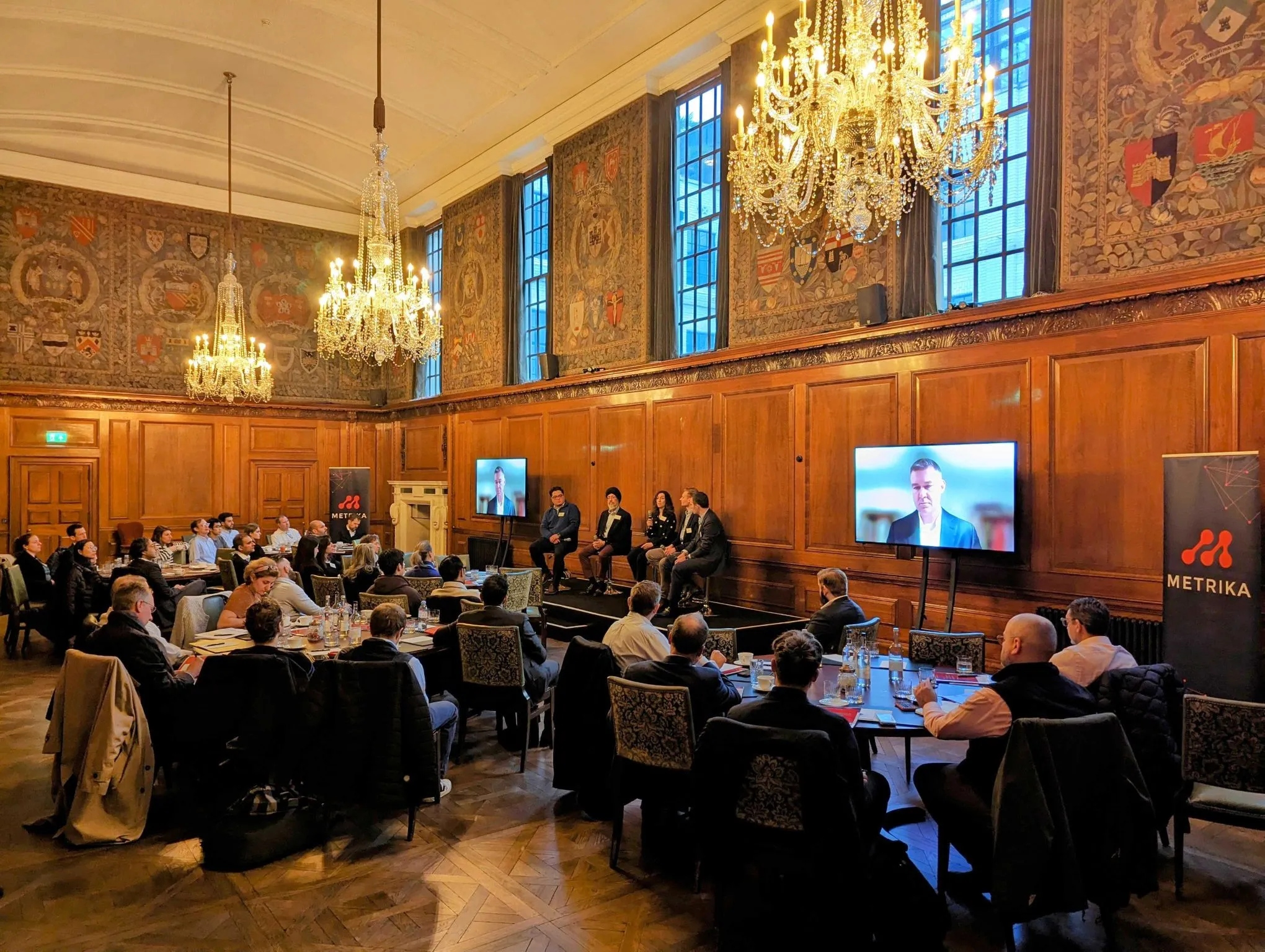 Conference room with attendees and Metrika presentation screens